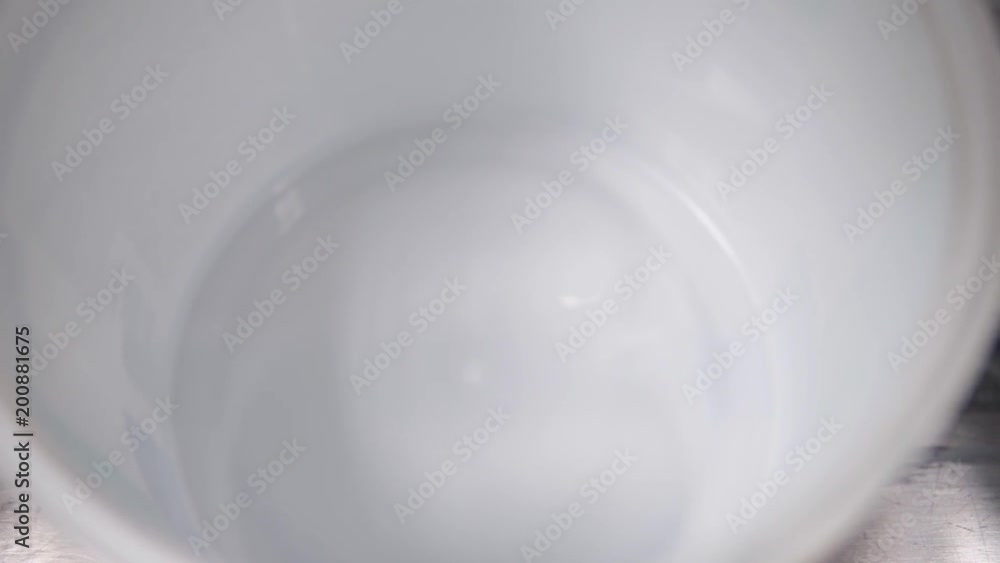 Liquid paints, paint is poured into jars, a jet of paint Liquid paints, paint is poured into jars, a jet of paint