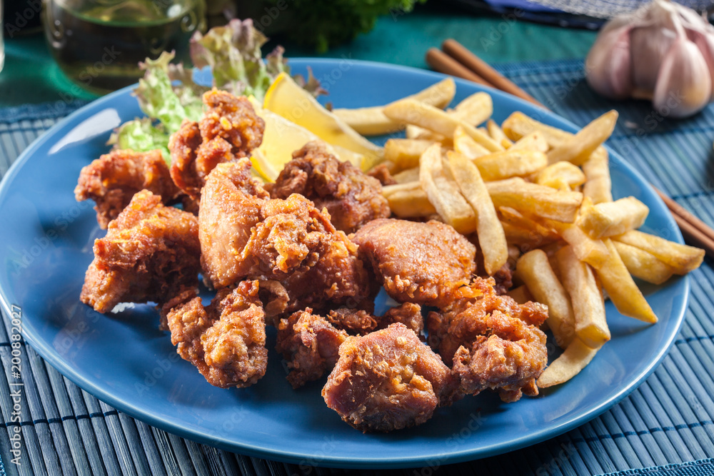 Crispy chicken karaage served with french fries Crispy chicken karaage served with french fries