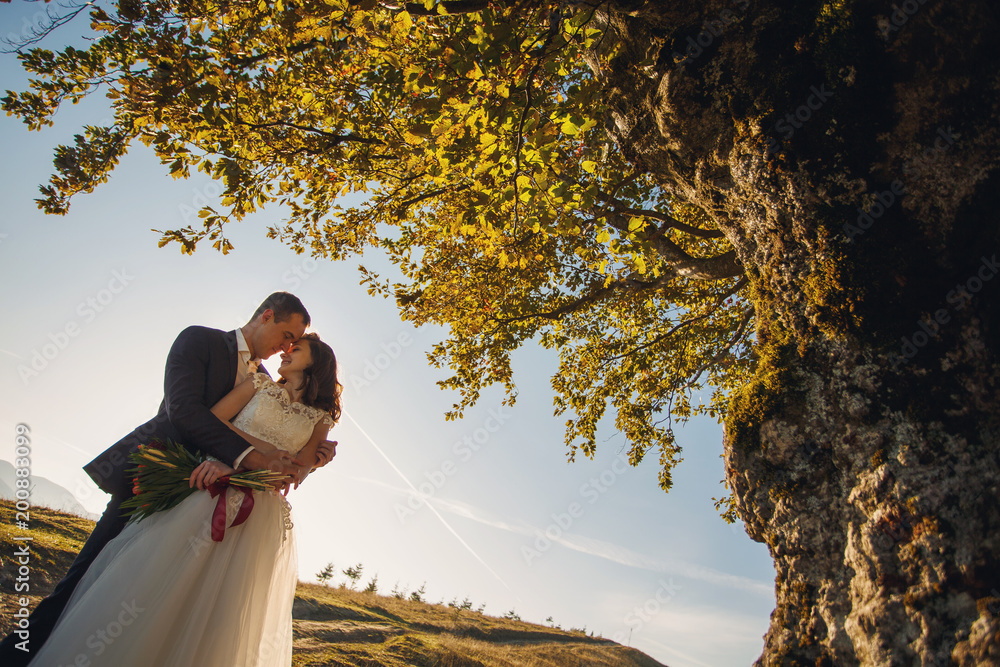 Man and woman Just married in the mountains at sunset. Man and woman Just married in the mountains at sunset.