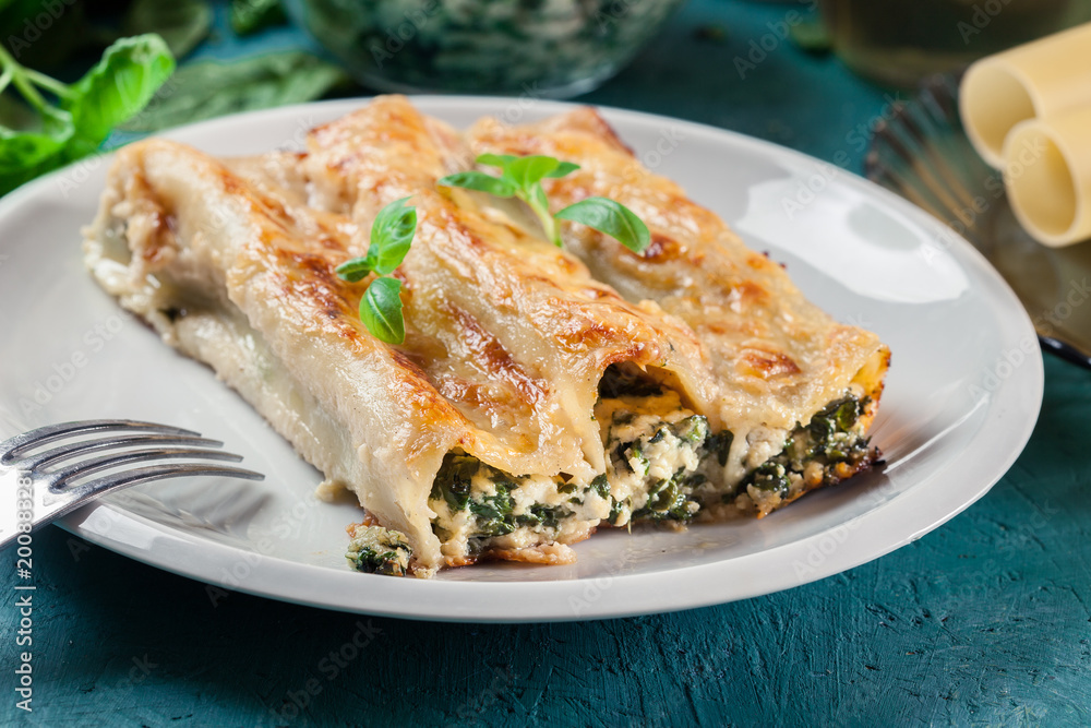 Portion of cannelloni stuffed with spinach Portion of cannelloni stuffed with spinach
