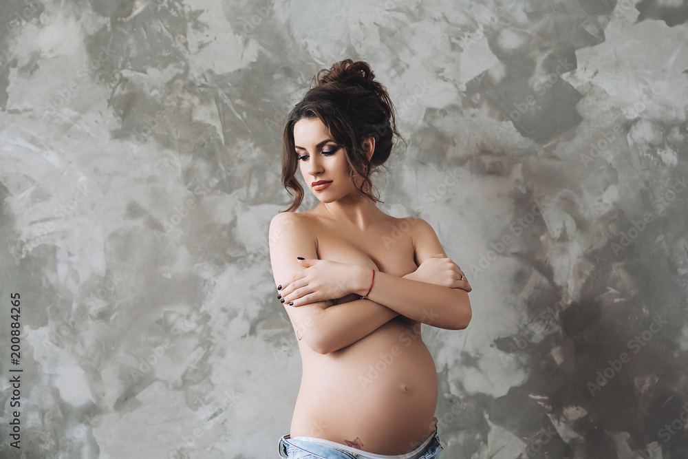 Erotic pregnant beauty in white