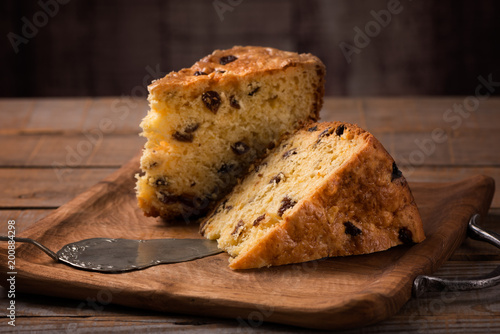 slices of home made cake with raisins on wooden plate