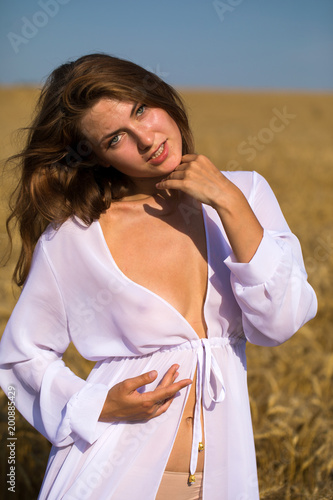 Brunette woman on wheat field
