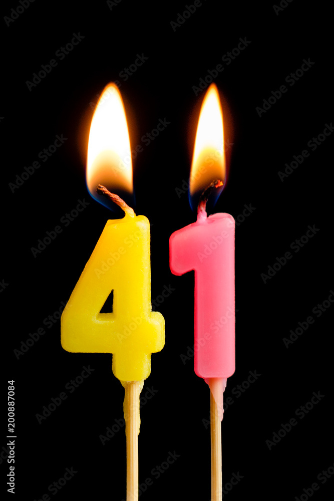 Burning candles in the form of 41 forty one (numbers, dates) for cake isolated on black background. The concept of celebrating a birthday, anniversary, important date, holiday, table setting Burning candles in the form of 41 forty one (numbers, dates) for cake isolated on black background. The concept of celebrating a birthday, anniversary, important date, holiday, table setting