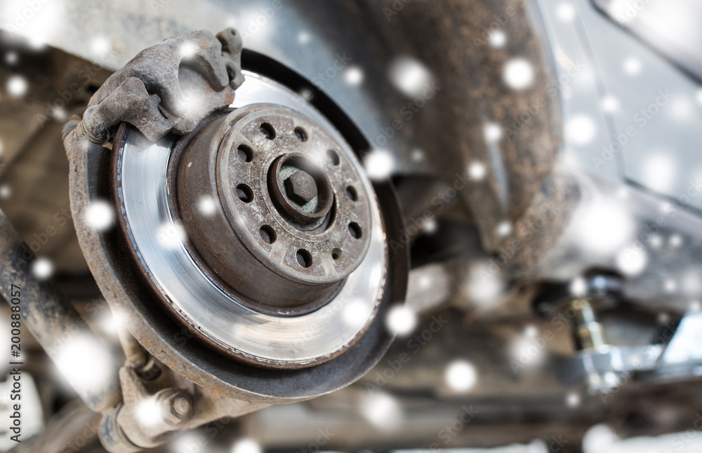 auto service and maintenance concept - car brake disc at repair station over snow auto service and maintenance concept - car brake disc at repair station over snow