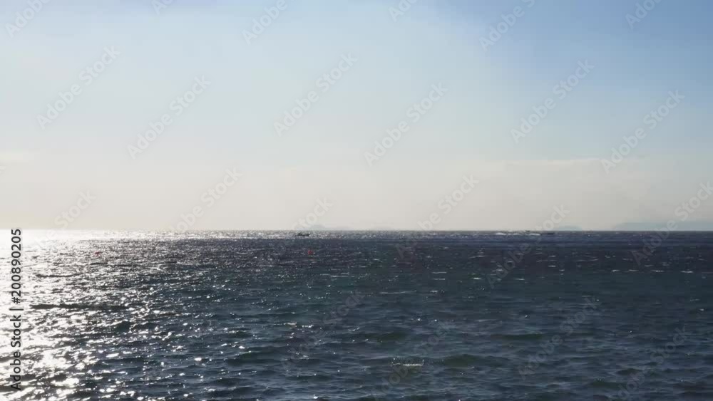 Clean sea water with sun path and boats Clean sea water with sun path and boats