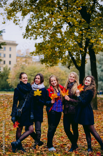 Female students strolling in the Park in autumn