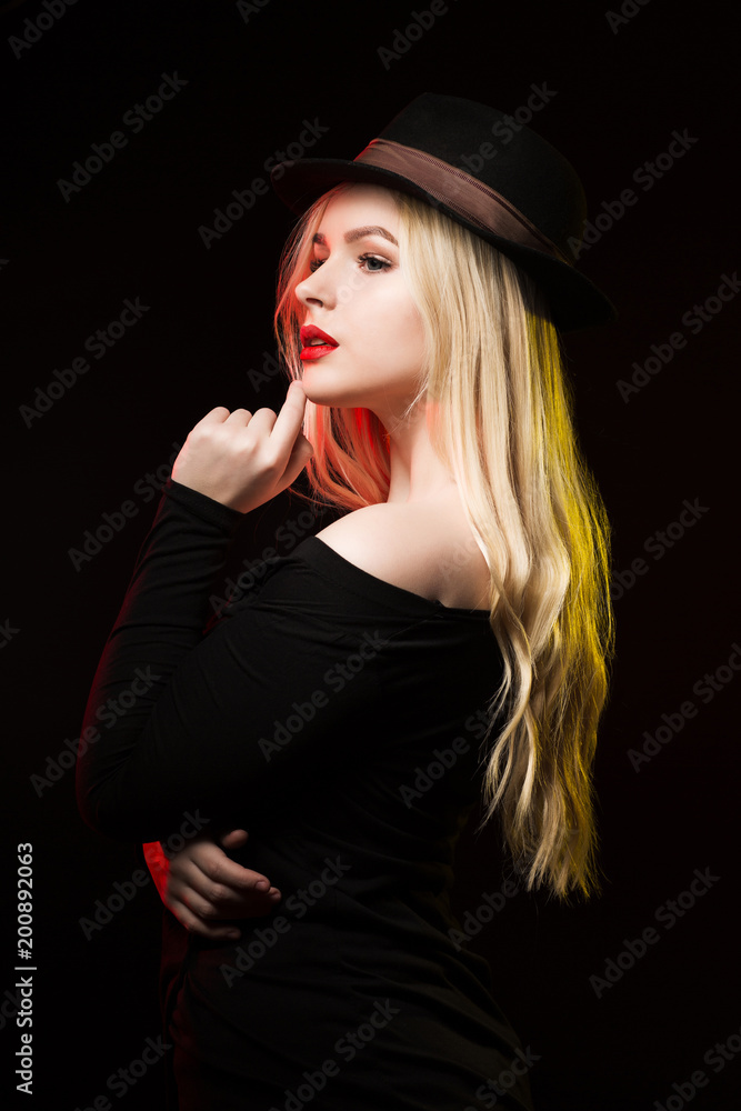 Amazing young woman with red lips posing over a dark background Amazing young woman with red lips posing over a dark background