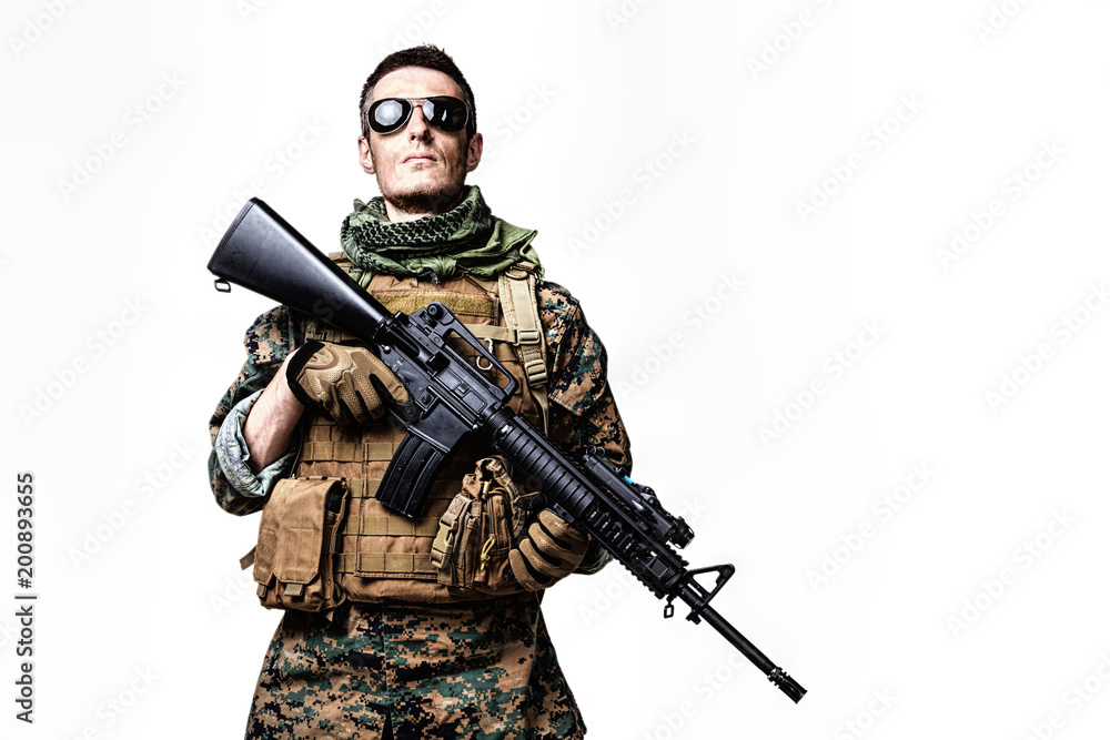 Studio shot of United States Marine with rifle weapons in uniforms. Military equipment, army helmet, combat boots, tactical gloves. Isolated on white, weapons, army, patriotism concept Studio shot of United States Marine with rifle weapons in uniforms. Military equipment, army helmet, combat boots, tactical gloves. Isolated on white, weapons, army, patriotism concept