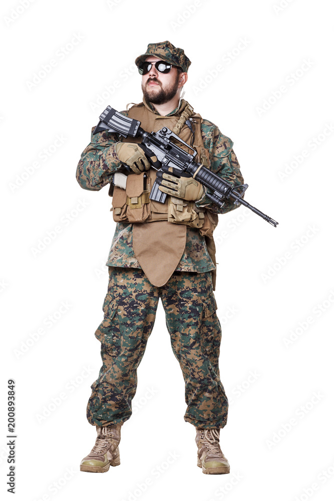 Studio shot of United States Marine with rifle weapons in uniforms. Military equipment, army helmet, combat boots, tactical gloves. Isolated on white, weapons, army, patriotism concept Studio shot of United States Marine with rifle weapons in uniforms. Military equipment, army helmet, combat boots, tactical gloves. Isolated on white, weapons, army, patriotism concept