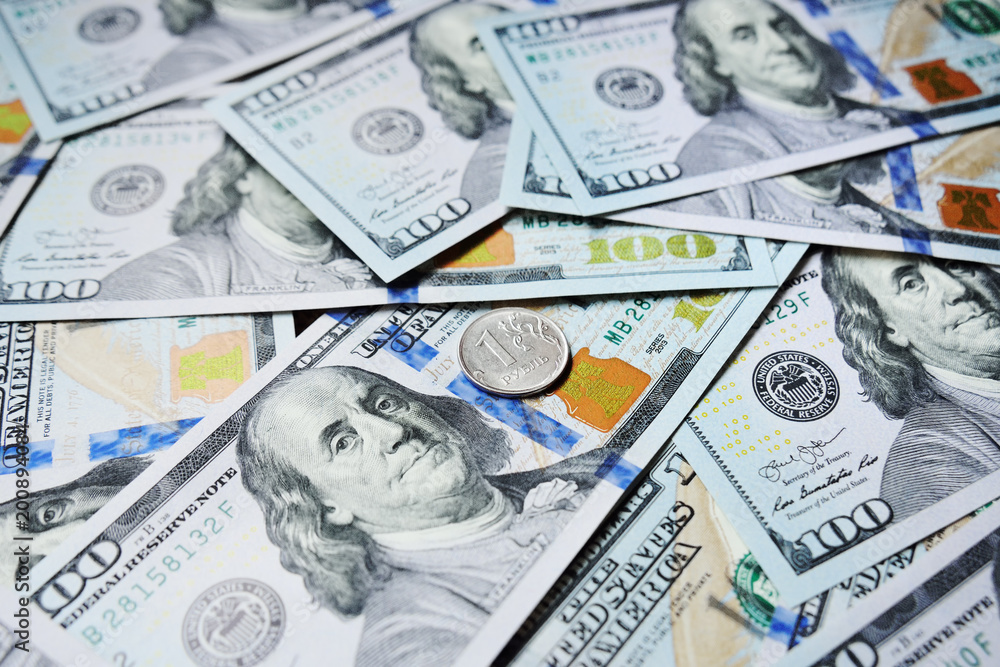 Fototapeta premium one Russian ruble against the background of dollars. Exchange Rates. The fall of the ruble and the growth of the dollar.