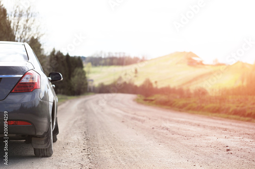 Car on a country road sunset background