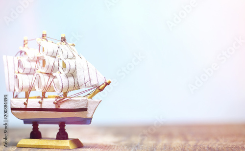 Old wooden ship with sails and masts toy on a stand. Vintage and