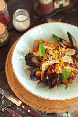 Fresh salad with mussels on a wooden table.