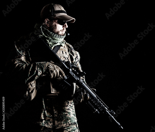 Studio shot of United States Marine with rifle weapons in uniforms. Military equipment  army helmet  combat boots  tactical gloves. Isolated on black  weapons  army  patriotism concept
