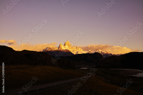 Rural road and the famed Fitz Roy mountain at dusk. Diminishing perspective. Panorama. © Nektarstock