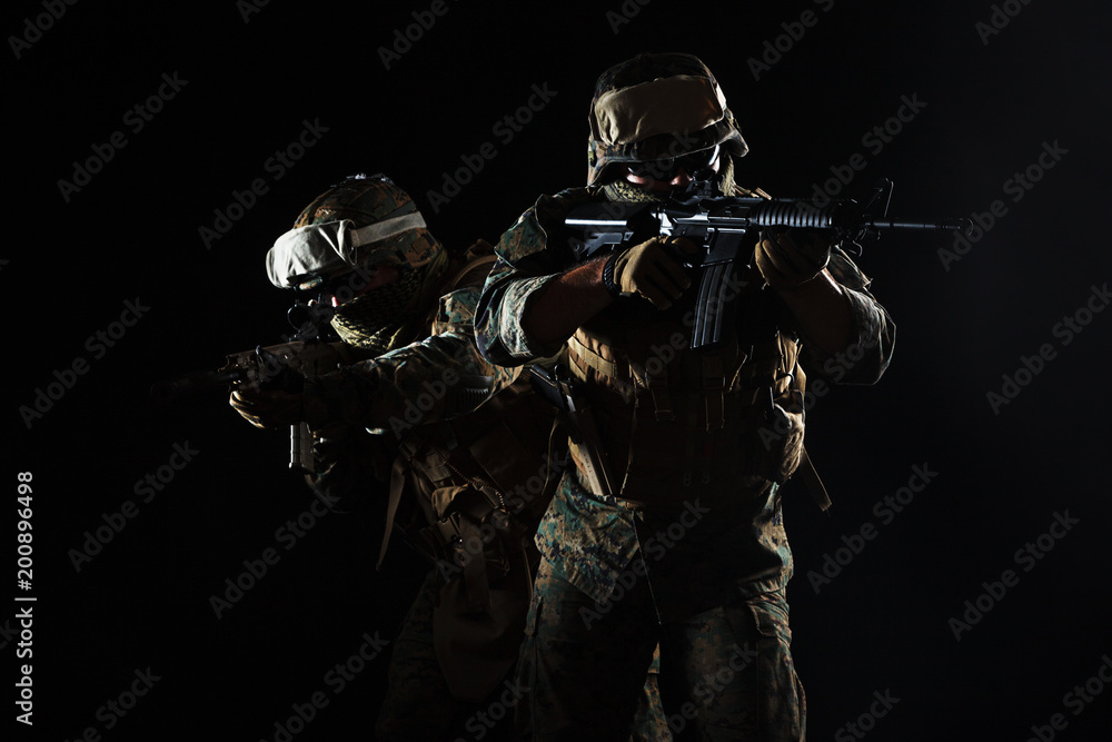 Studio shot of United States Marine with rifle weapons in uniforms. Military equipment, army helmet, combat boots, tactical gloves. Isolated on white, weapons, army, patriotism concept Studio shot of United States Marine with rifle weapons in uniforms. Military equipment, army helmet, combat boots, tactical gloves. Isolated on white, weapons, army, patriotism concept