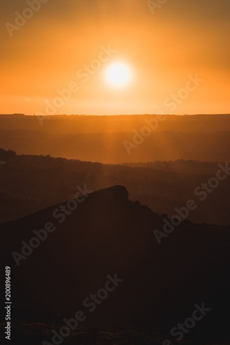 In the shadow of a Sunset, Sun setting over a mountain peak © Stephen Davies