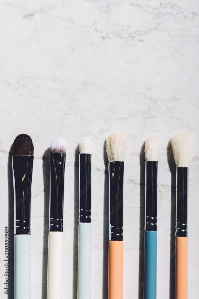 Six makeup brushes laying together. Six makeup brushes laying together.