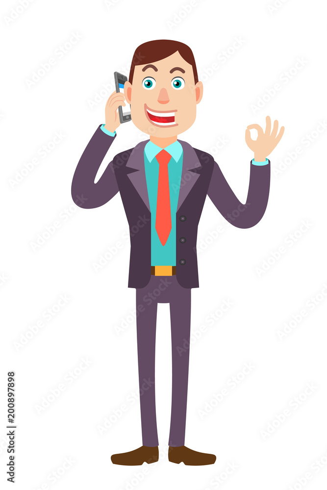 Businessman talking on mobile phone and showing a okay hand sign Businessman talking on mobile phone and showing a okay hand sign