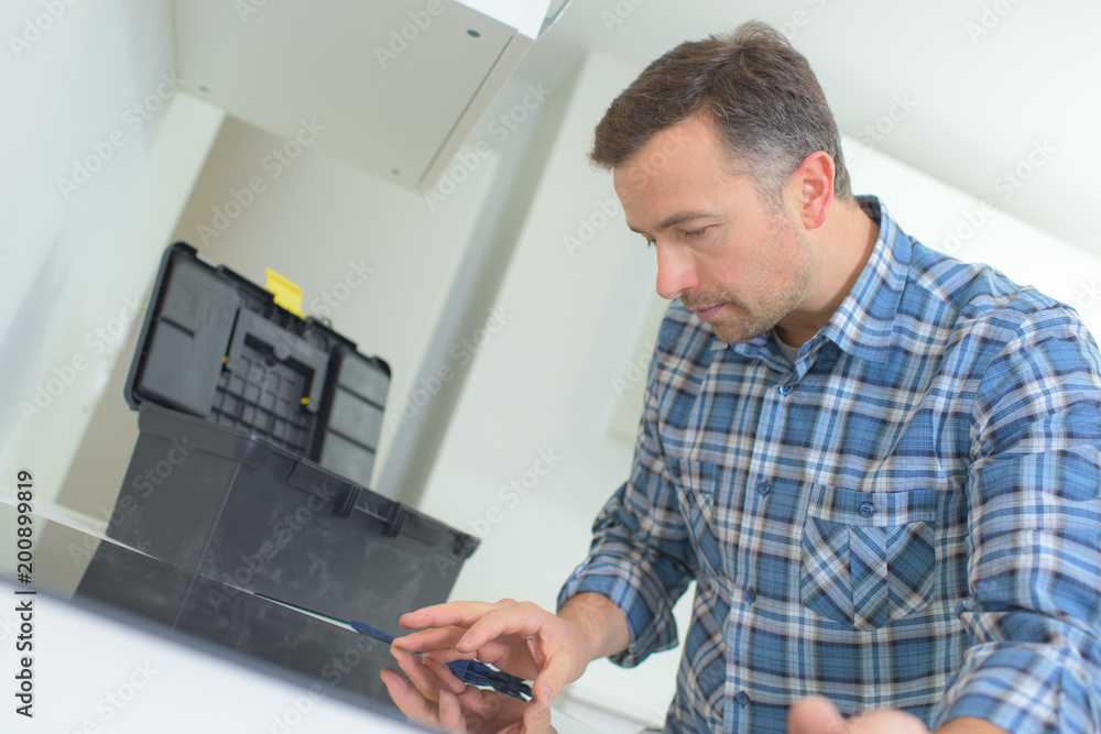 Man repairing electric hob Man repairing electric hob