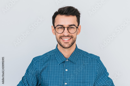 Closeup portrait of handsome smart-looking smiling with toothy smile male posing for social advertisement, isolated on white background with copy space for your promotional information or content.