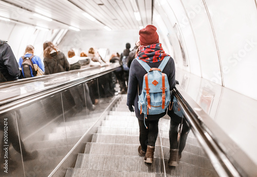 People stand on the escalator in the metro or subway, the concept of public urban underground transport photo