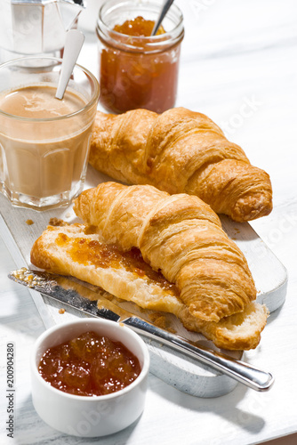 croissants with orange jam and coffee with milk