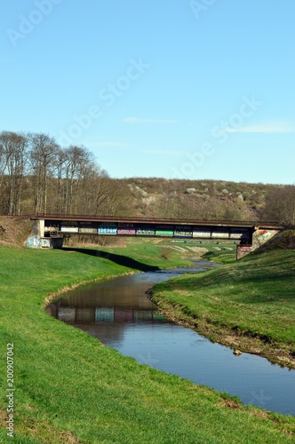 Railway bridge, in very scenic landscape with river in germany, at Leipzig