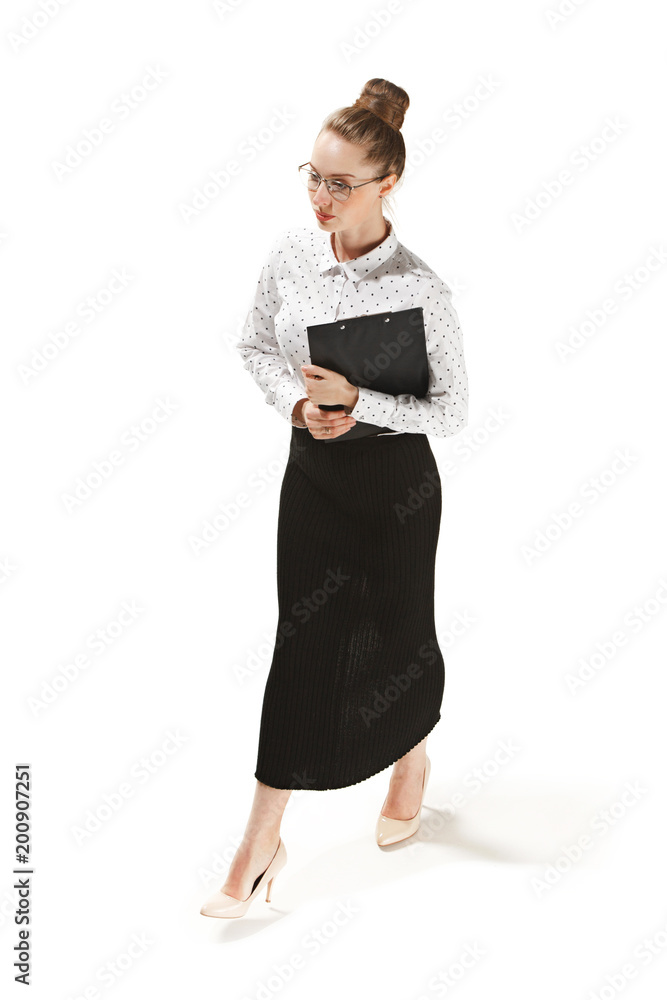 Full length portrait of a smiling female teacher holding a folder isolated against white background Full length portrait of a smiling female teacher holding a folder isolated against white background