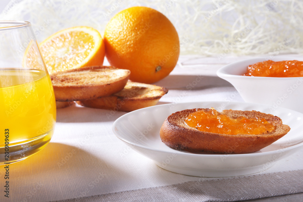Morning Breakfast set with orange jam on bread toast and juice in glass. Morning Breakfast set with orange jam on bread toast and juice in glass.