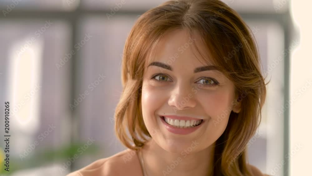 people, emotion and facial expression concept - face of happy smiling young woman people, emotion and facial expression concept - face of happy smiling young woman