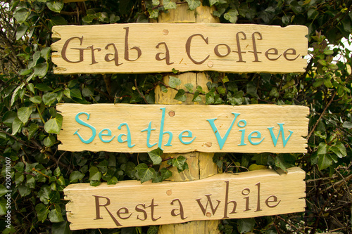 Cornwall cafe colourful signage grab a coffee sea the view rest a while
