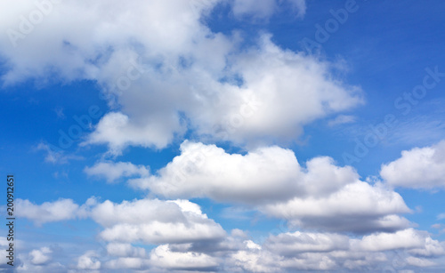 Summer blue sky with cumulus clouds. Heavenly landscape. Natural abstract background photo