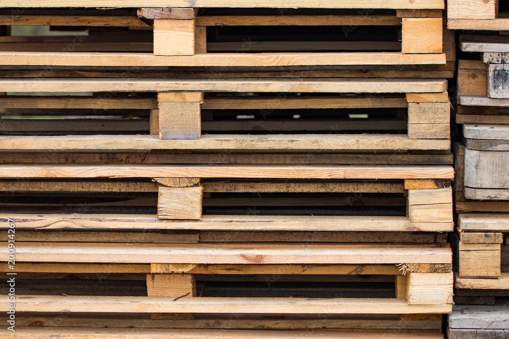 Stacks of Wooden pallets for industrial transportation by trucks Stacks of Wooden pallets for industrial transportation by trucks