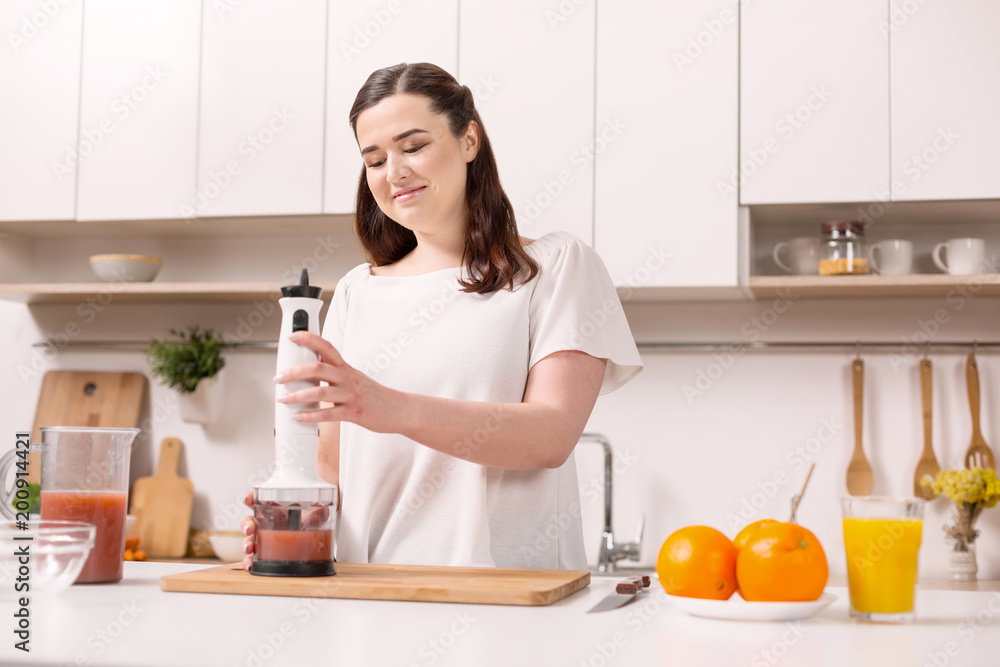 Detox day. Pretty nice woman using blender and staring down Detox day. Pretty nice woman using blender and staring down