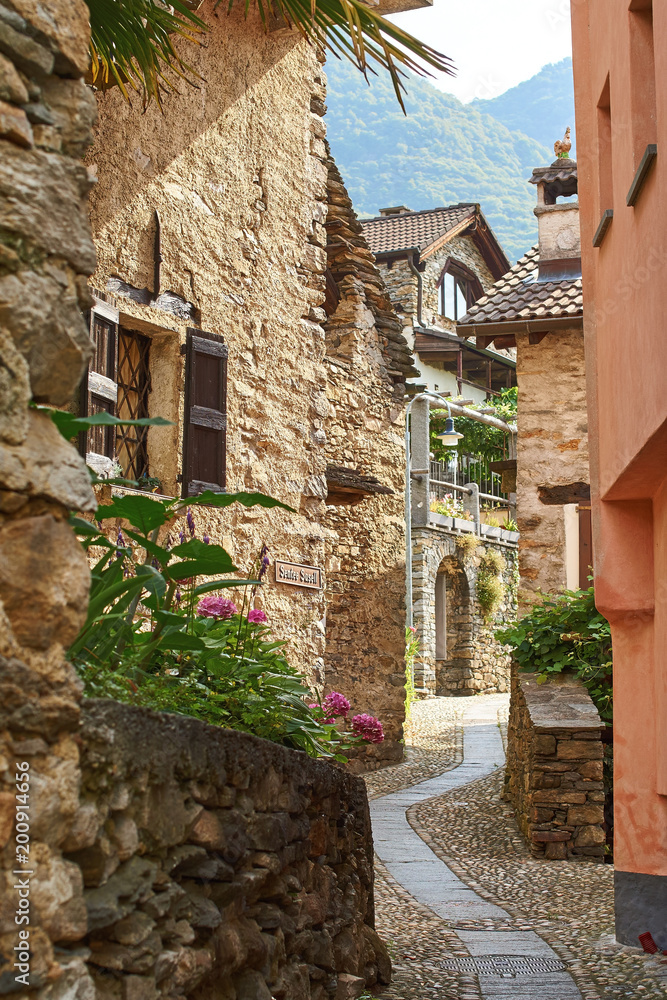 Typical narrow rural Swiss mountain village street in Southern Switzerland, Canton of Ticino near Bellinzona