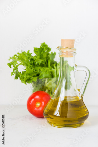 Olive oil, green salad lettuce and fresh tomato