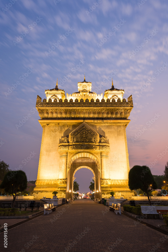 Front view of the lit Patuxai (Victory Gate or Gate of Triumph) war monument in Vientiane, Laos, at dusk.