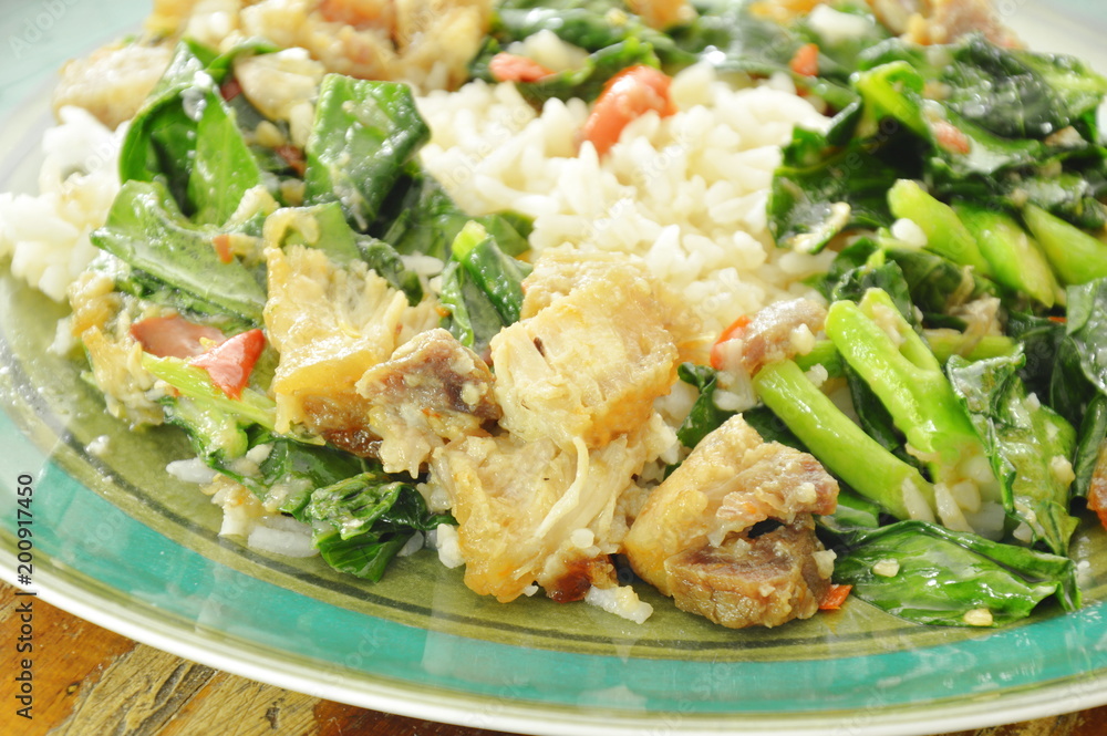 stir fried Chinese kale and crispy pork with chili on rice stir fried Chinese kale and crispy pork with chili on rice