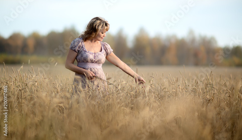 mature woman in wheat field