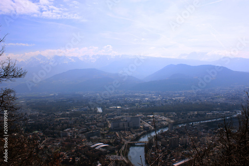 Skyline of French Alps. Comparing concept in French Alps. Small city and mountains above. Grenoble, France