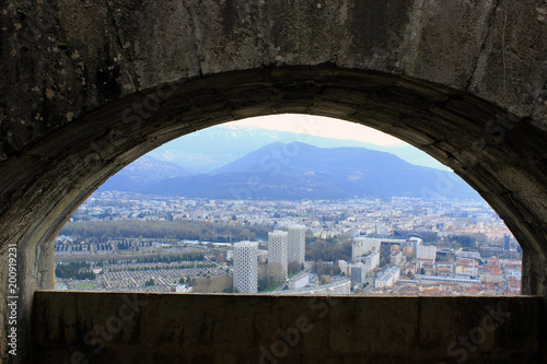French Alps through the window in the wall in Grenoble, France