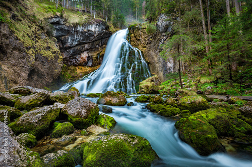 Fototapeta Naklejka Na Ścianę i Meble -  Idyllic waterfall scene with mossy rocks in the forest