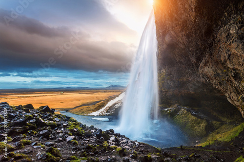 Seljalandsfoss waterfall during the sunset  Beautiful waterfall in Iceland.