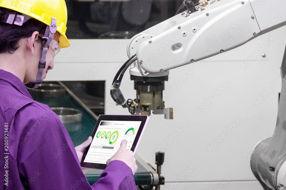 Industry 4.0 Robot concept .Engineers use laptop computers for machine ...