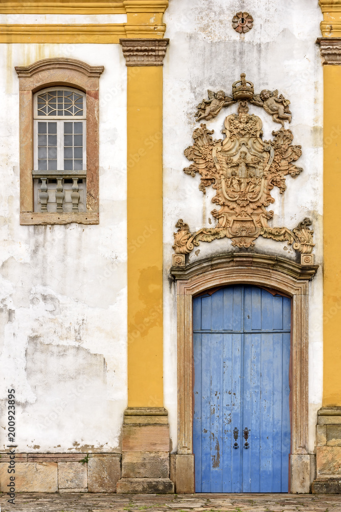 Old withe and yellow catholic church facade of the 18th century located in the center of the famous and historical city of Ouro Preto in Minas Gerais