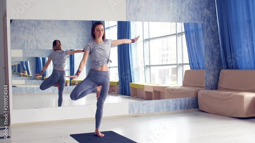 Sporty young woman doing yoga practice - concept of healthy life and natural balance between body and mental development. photo