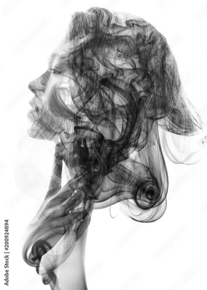 Double exposure profile portrait of a young sexy woman with pouty lips and a smoky texture dissolving into her facial features and hair Double exposure profile portrait of a young sexy woman with pouty lips and a smoky texture dissolving into her facial features and hair