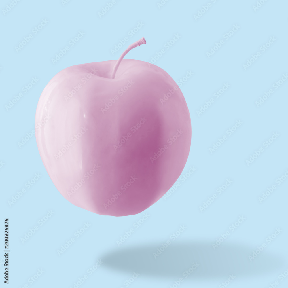 Naklejka Różowe jabłko na niebieskim tle. Minimalistyczny styl. Koncepcja żywności.